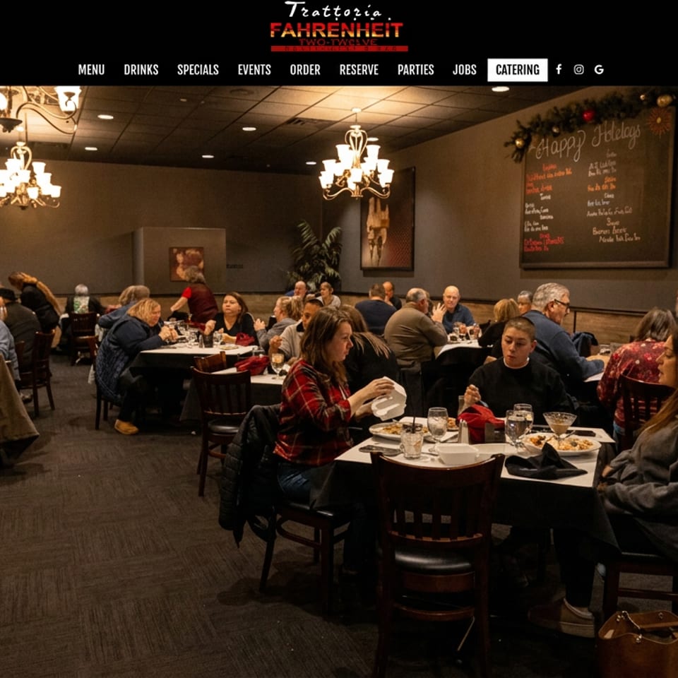 Busy Italian restaurant dining room filled with patrons at tables, warm chandelier lighting, festive decorations, and a holiday specials chalkboard.